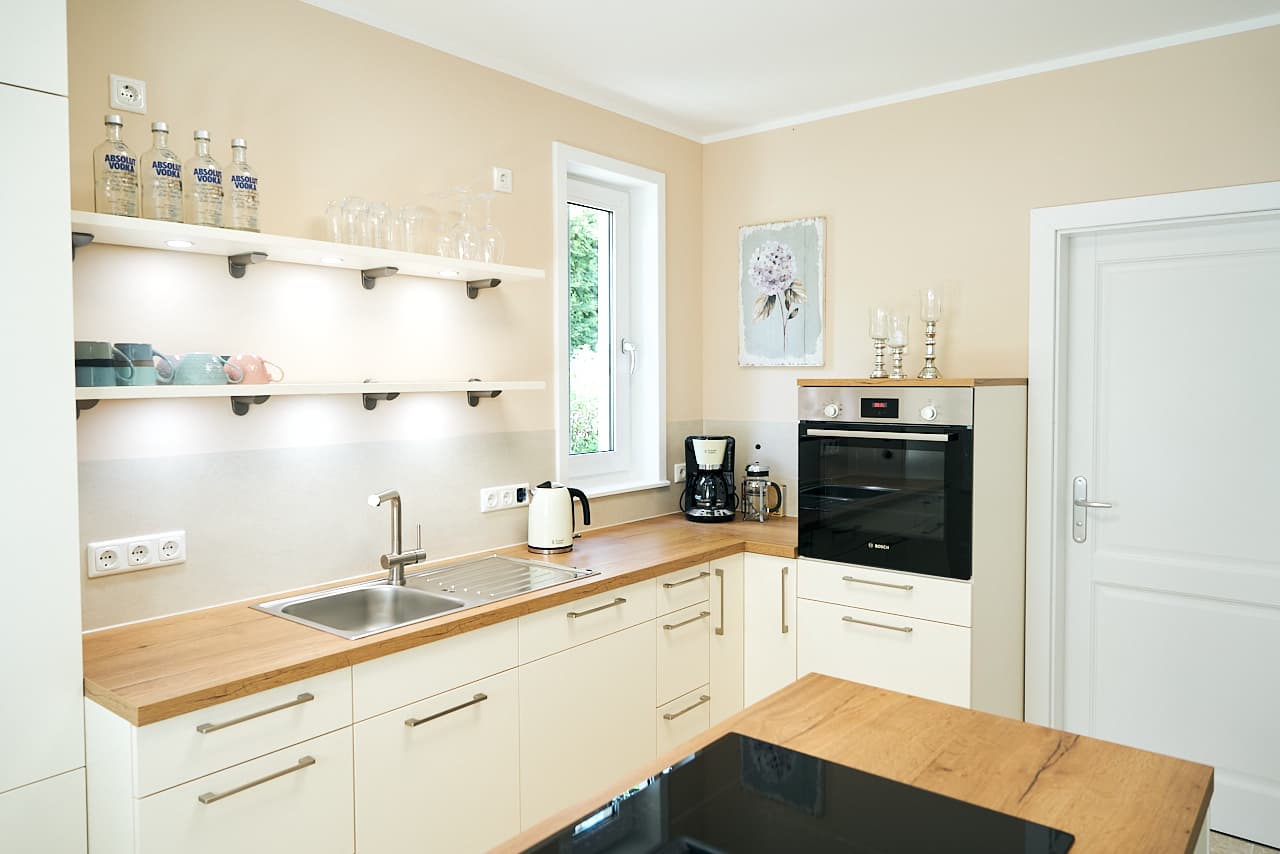 Close-up of a kitchen backsplash with intricate mosaic tiles.
