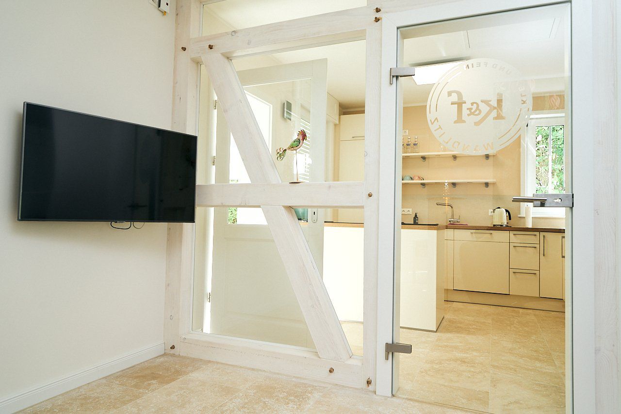 Spacious living room with wood-effect floor tiles.
